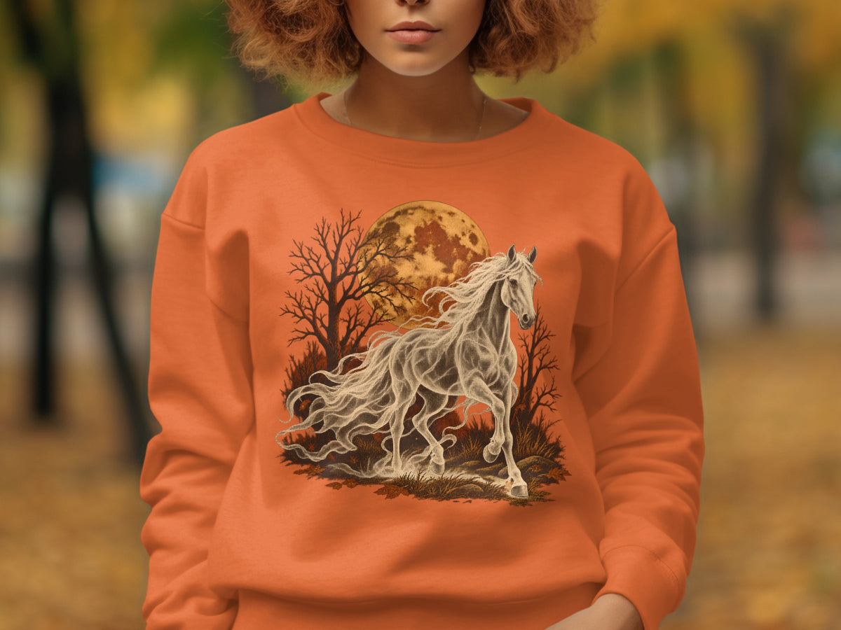 Orange sweatshirt with a spectral horse, bare trees, and full moon graphic.