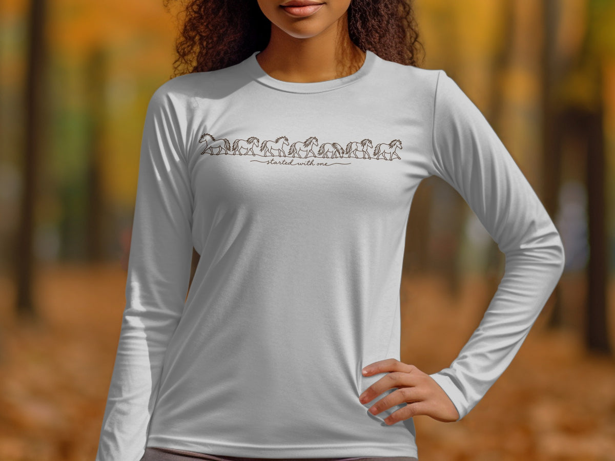 White long-sleeve shirt with a line of horses and text "started with one".