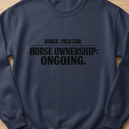 Navy sweatshirt with black text "HORSE: PAID FOR. HORSE OWNERSHIP: ONGOING."