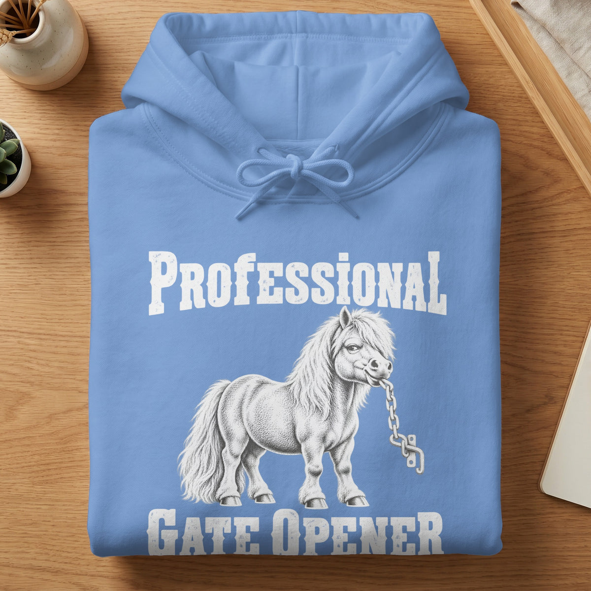 Light blue hooded sweatshirt with a white graphic of a pony biting a chain and text reading Professional Gate Opener.