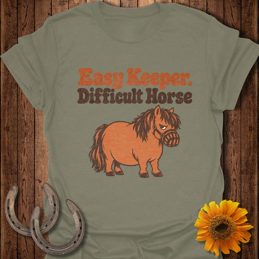 Green t-shirt with "Easy Keeper. Difficult Horse." text and a grumpy pony illustration.