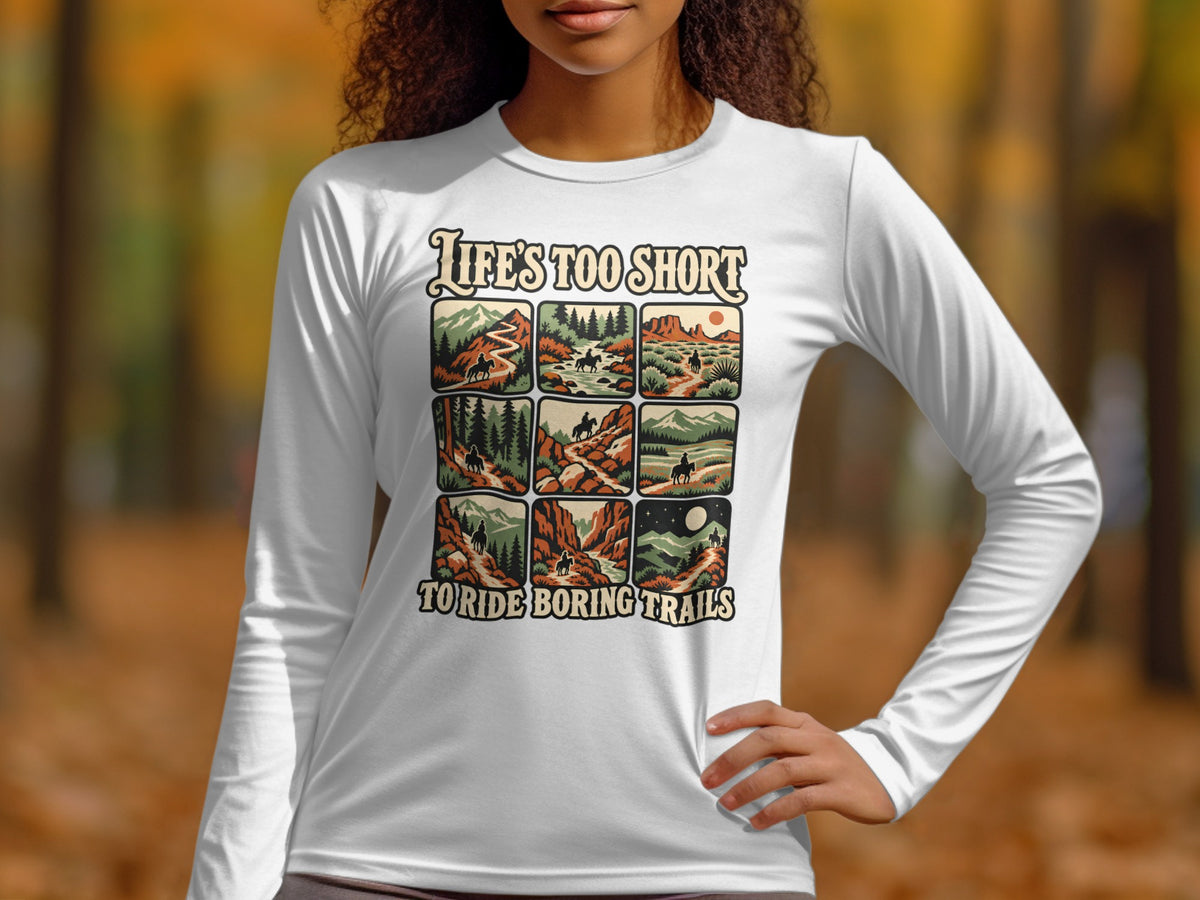 White long-sleeve shirt with "Life's Too Short To Ride Boring Trails" and nine trail riding scenes.