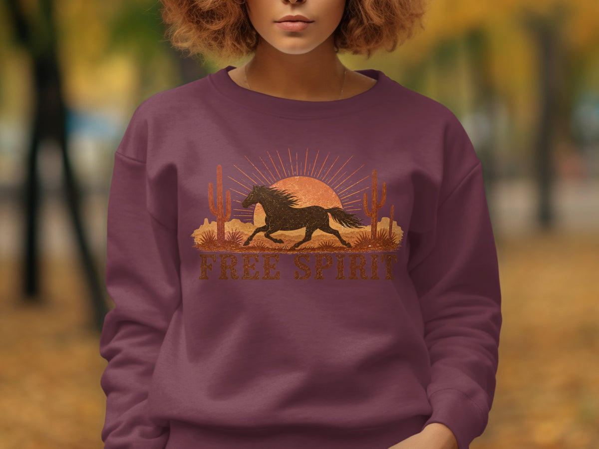 Burgundy sweatshirt with desert horse graphic and "FREE SPIRIT" text.