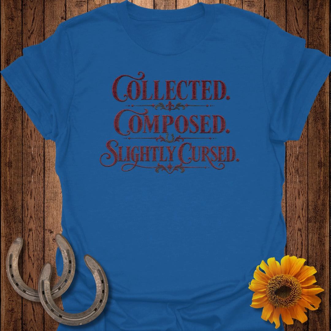 Blue t-shirt with "Collected. Composed. Slightly Cursed." text and horseshoes.