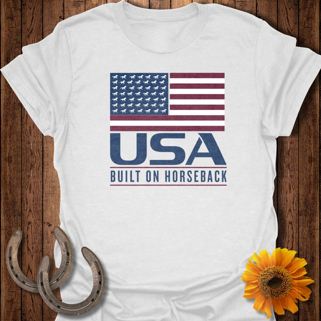 White t-shirt with USA Built on Horseback text and a horse-filled US flag graphic.
