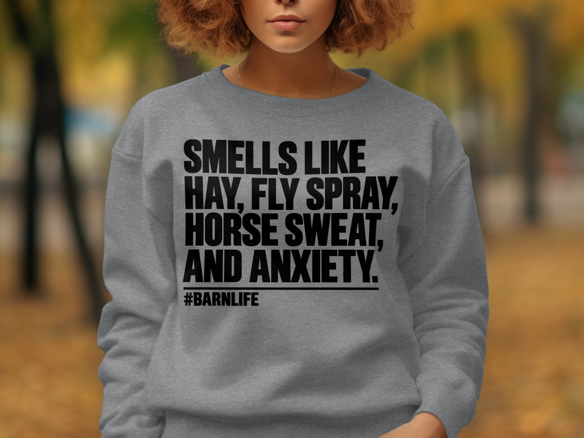 Grey sweatshirt with black text: Smells like hay, fly spray, horse sweat, and anxiety. #BarnLife