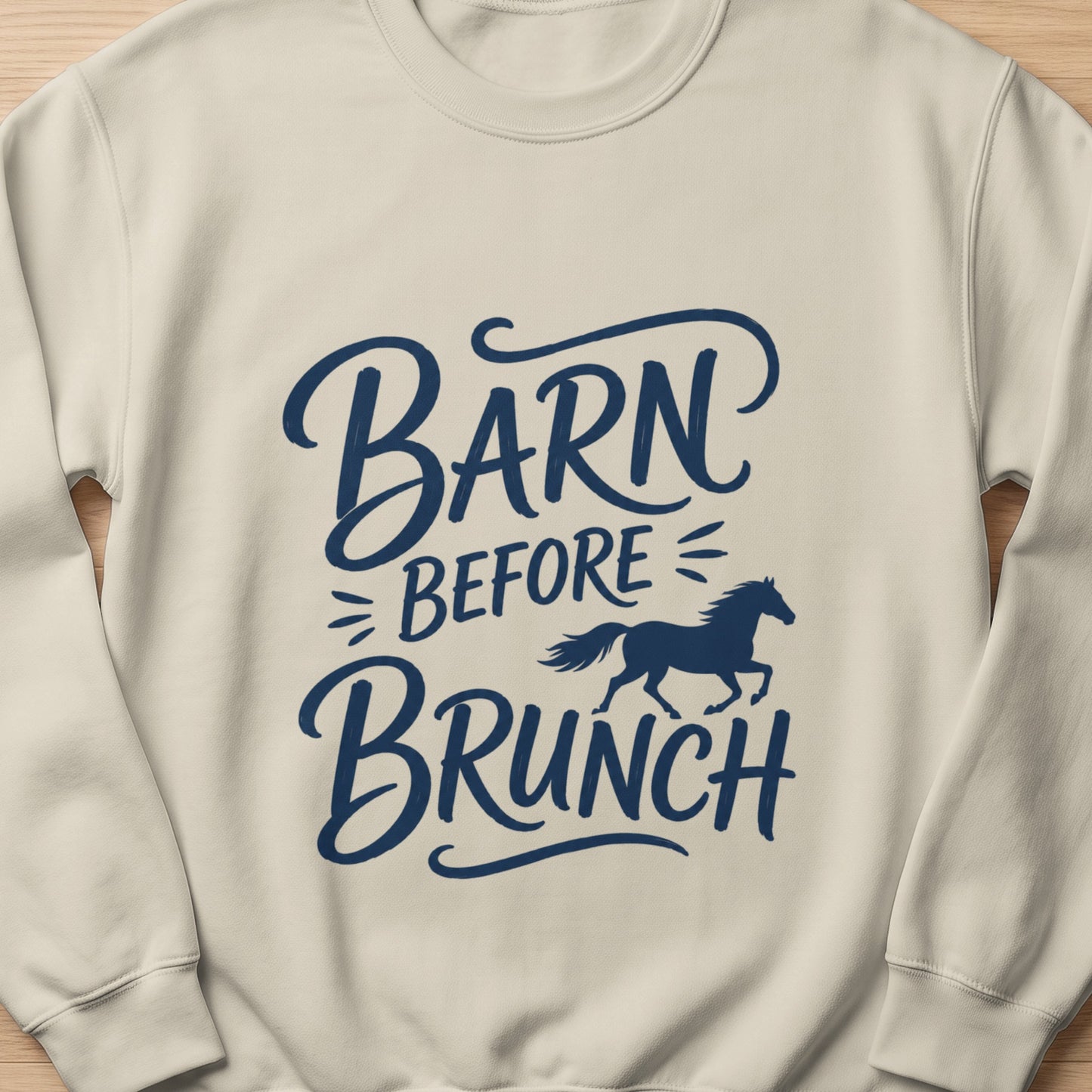 Cream sweatshirt with dark blue text "Barn Before Brunch" and a silhouette of a running horse.