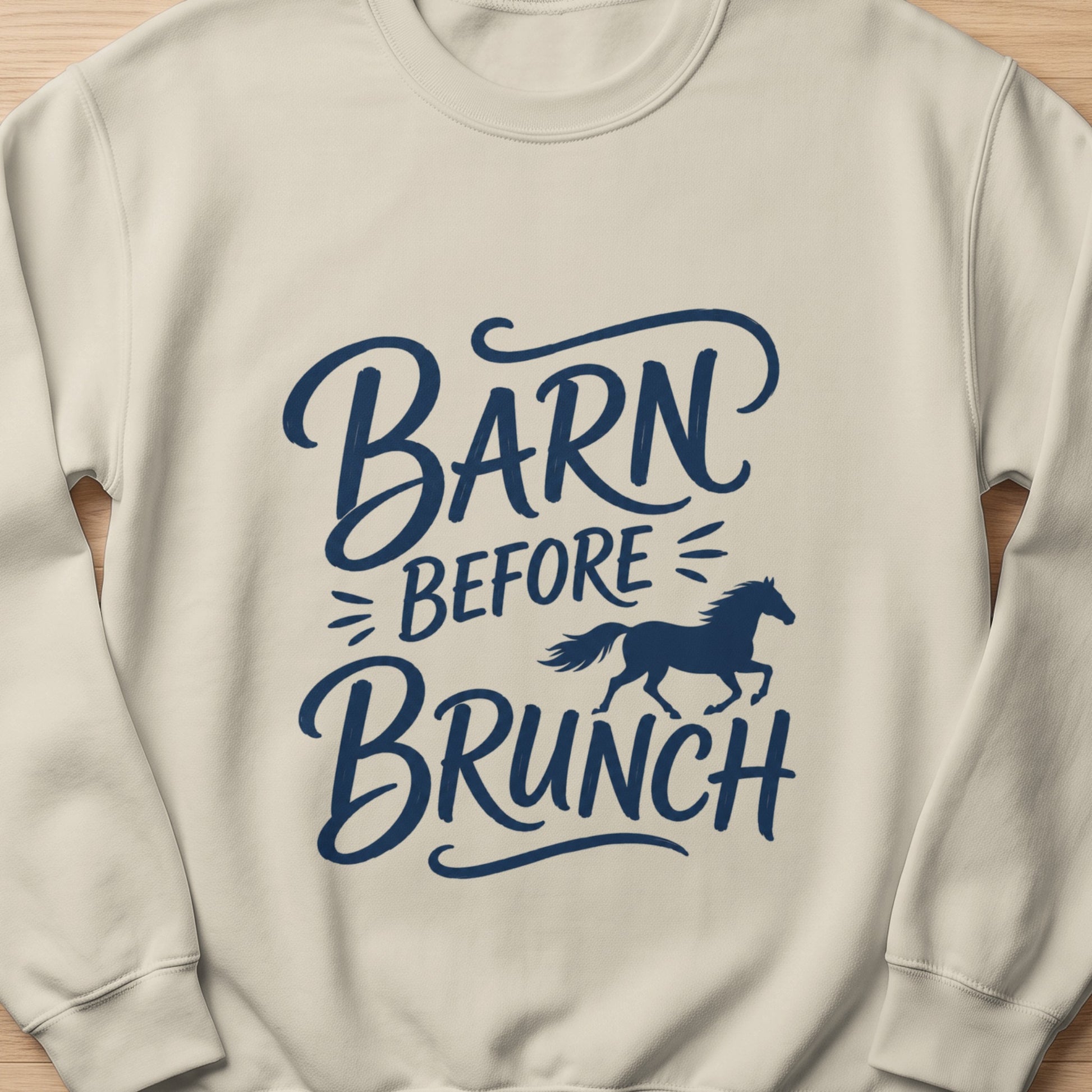 Cream sweatshirt with dark blue text "Barn Before Brunch" and a silhouette of a running horse.