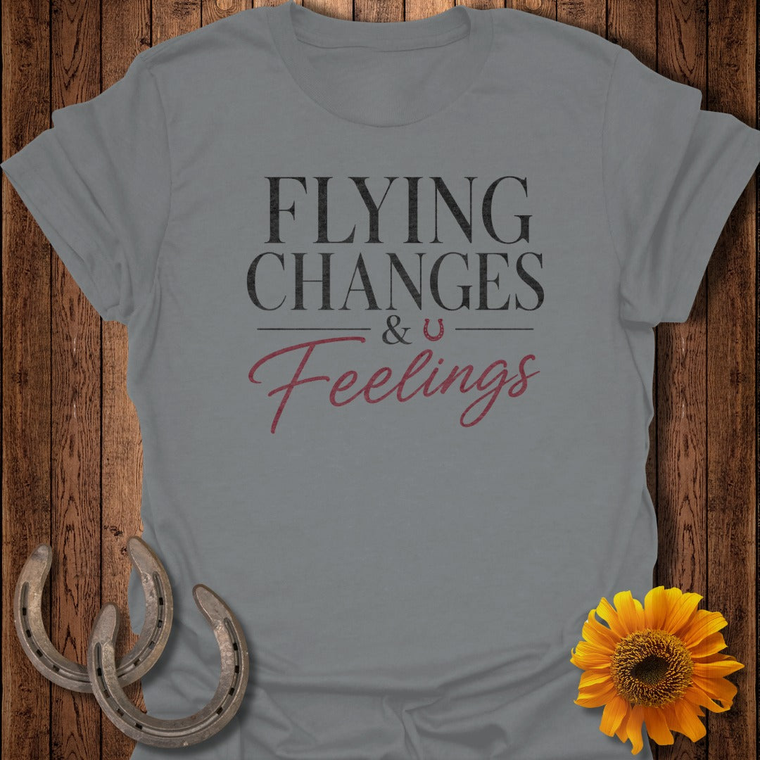 Grey t-shirt with "Flying Changes & Feelings" text and horseshoe graphic.