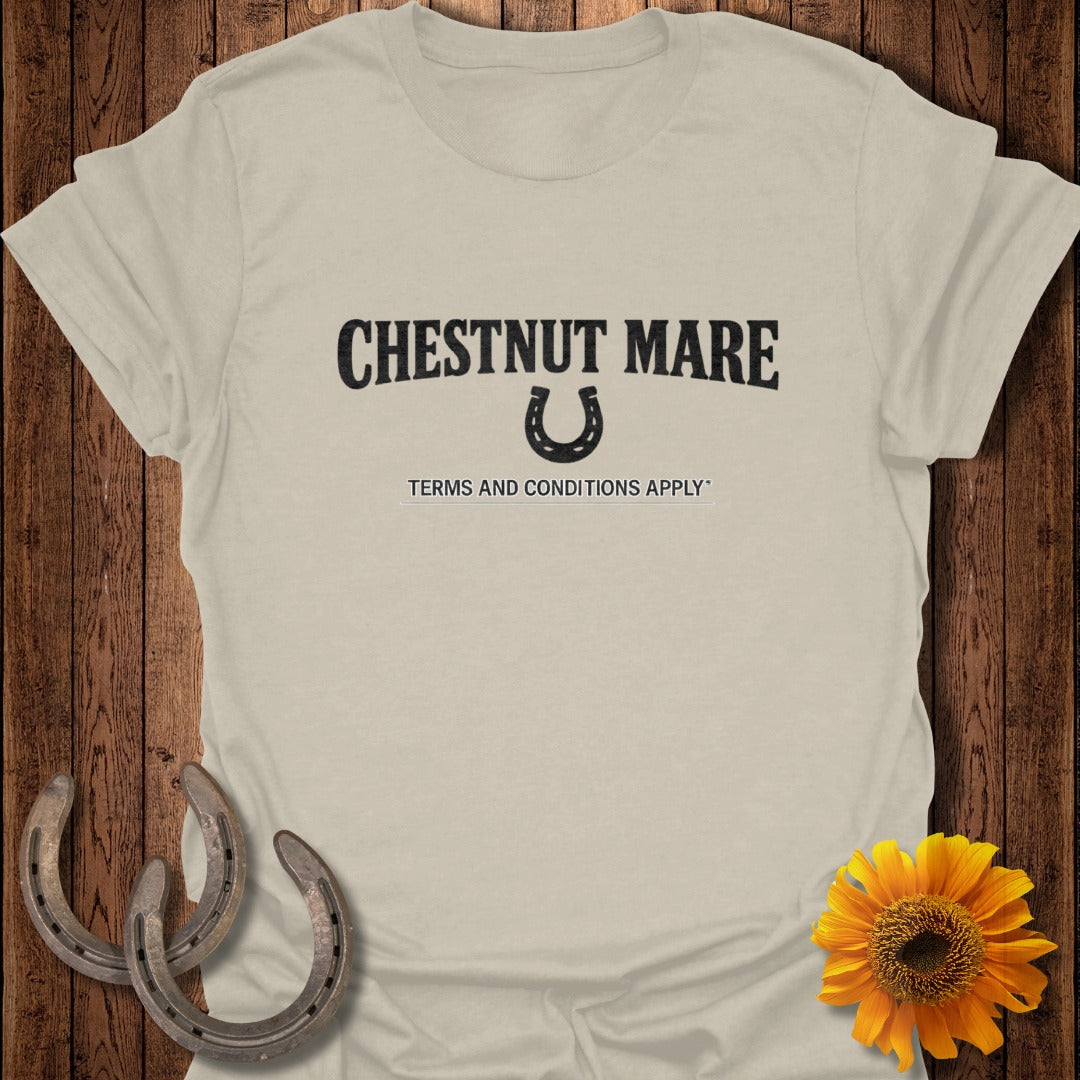 Light beige t-shirt with "CHESTNUT MARE" text, horseshoe graphic, and "TERMS AND CONDITIONS APPLY" text.