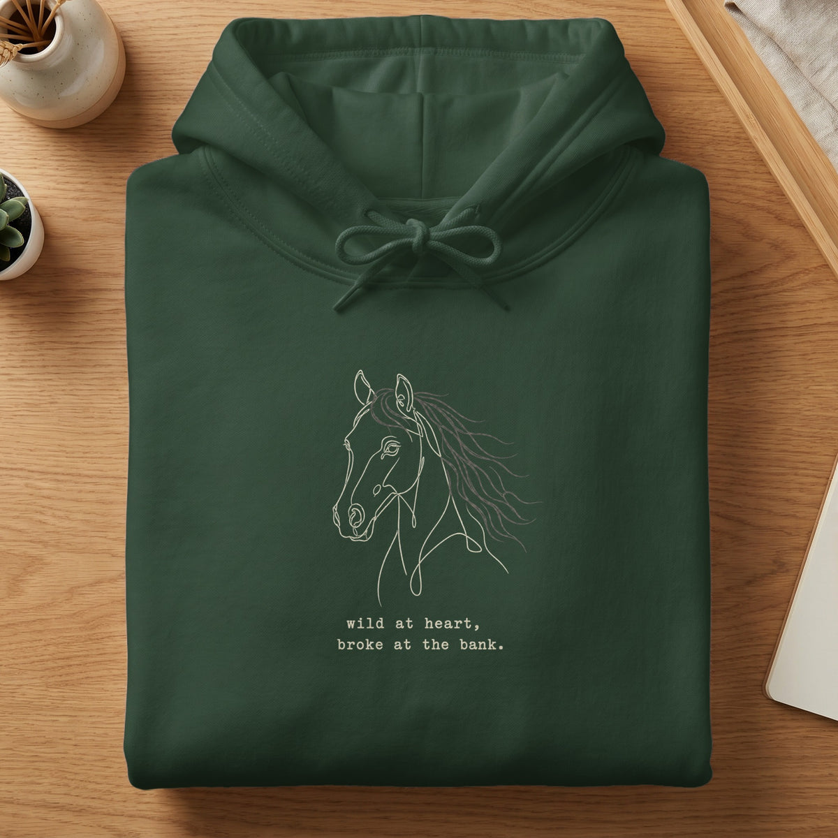Dark green hoodie with a white line drawing of a horse and text.