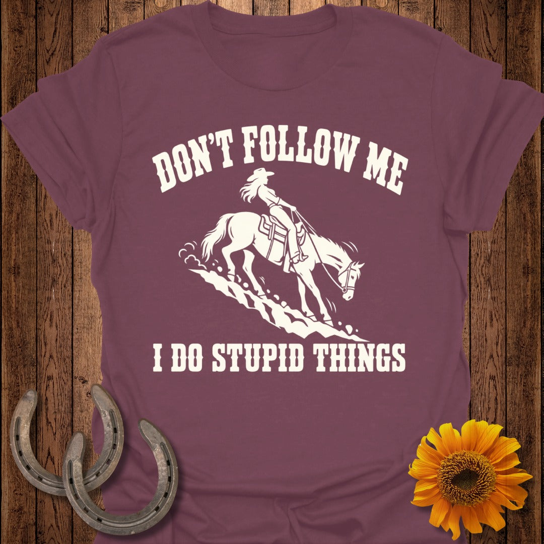 Burgundy t-shirt with "Don't follow me, I do stupid things" and a rider on a horse.