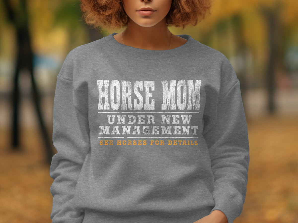 Gray sweatshirt with "Horse Mom Under New Management" text.