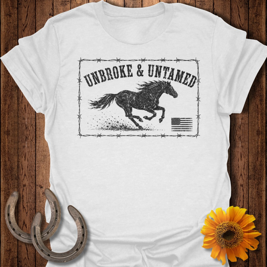 White t-shirt with black distressed graphic of a running horse, American flag, and text "UNBROKE & UNTAMED".