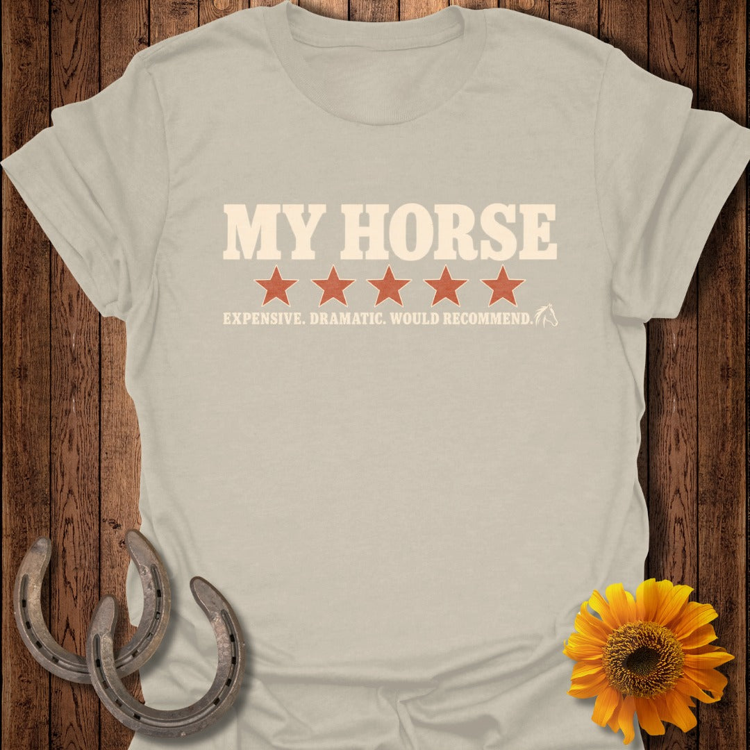 A beige t-shirt displays the text My Horse above five red stars and the phrase Expensive. Dramatic. Would Recommend.