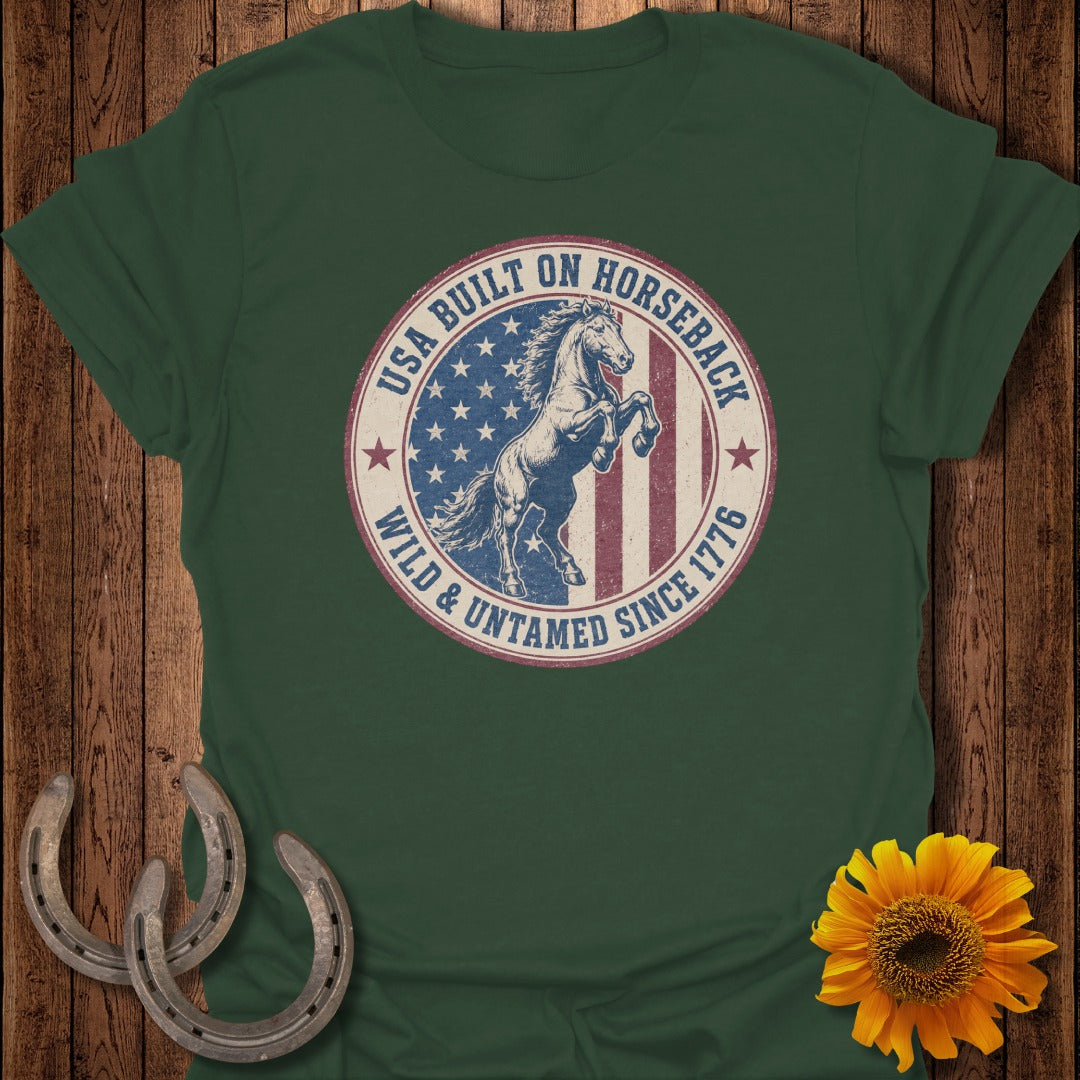 Green t-shirt featuring a circular graphic with a horse, USA flag, and text.