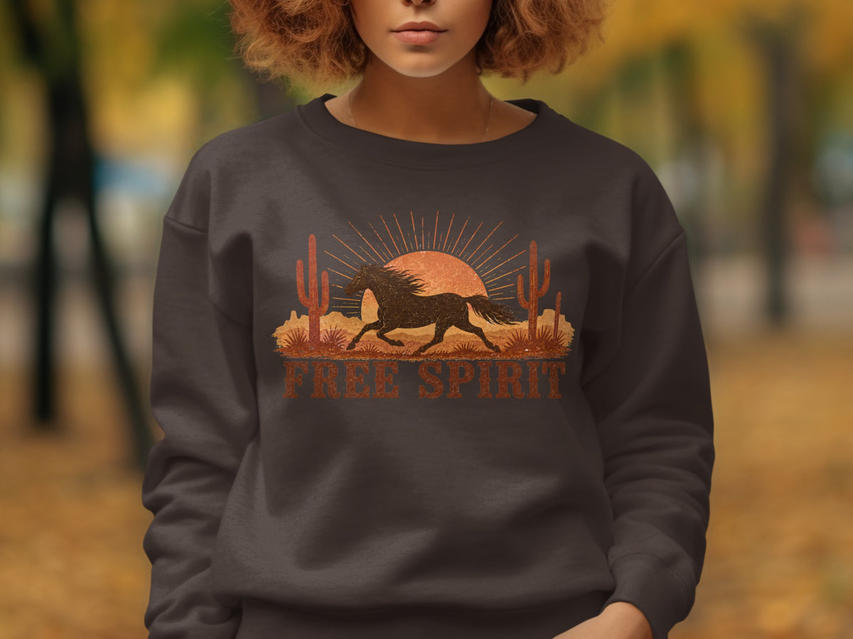 Dark sweatshirt with vintage desert horse and sunset graphic, "Free Spirit" text.