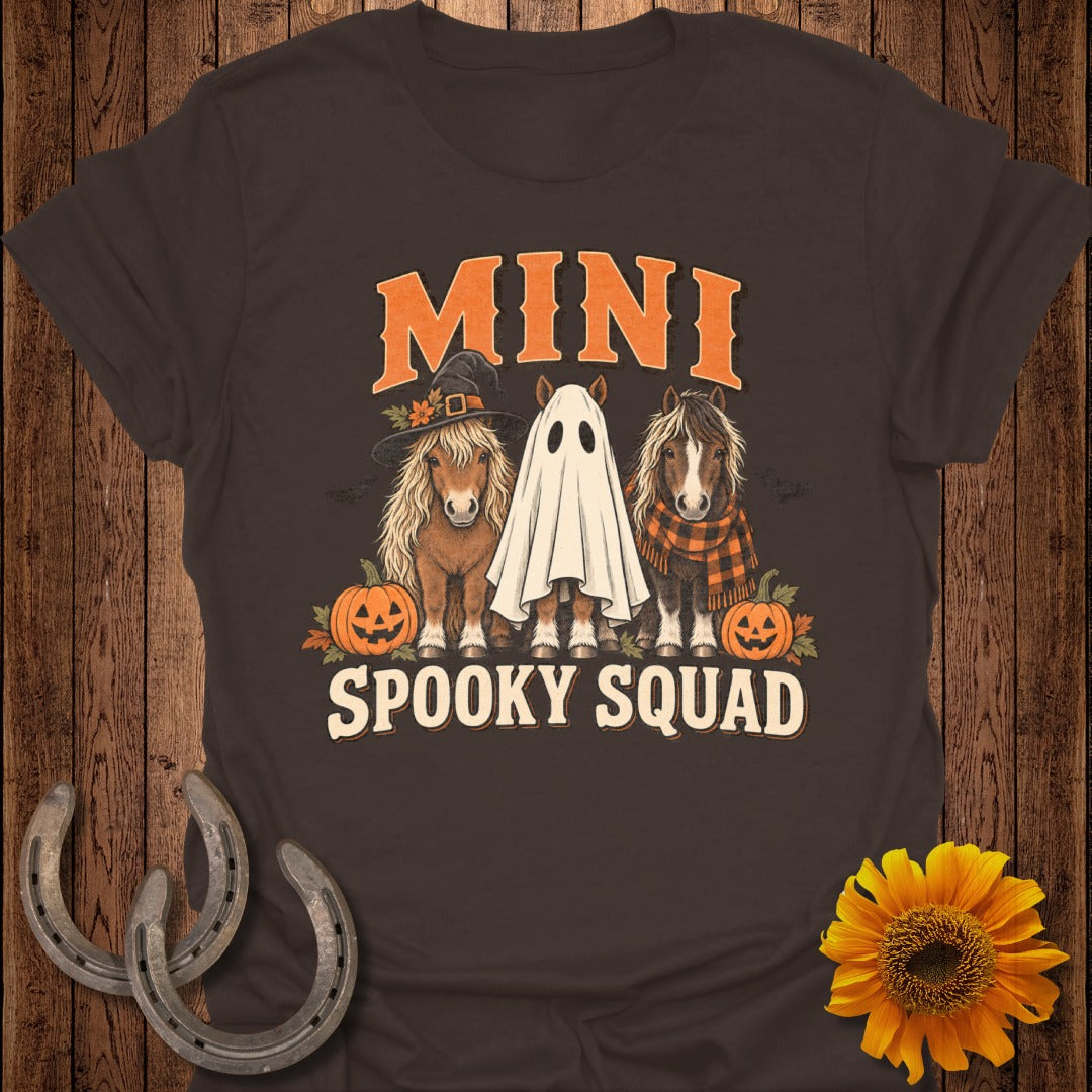 T-shirt graphic featuring three ponies dressed for Halloween with pumpkins and text "MINI SPOOKY SQUAD".