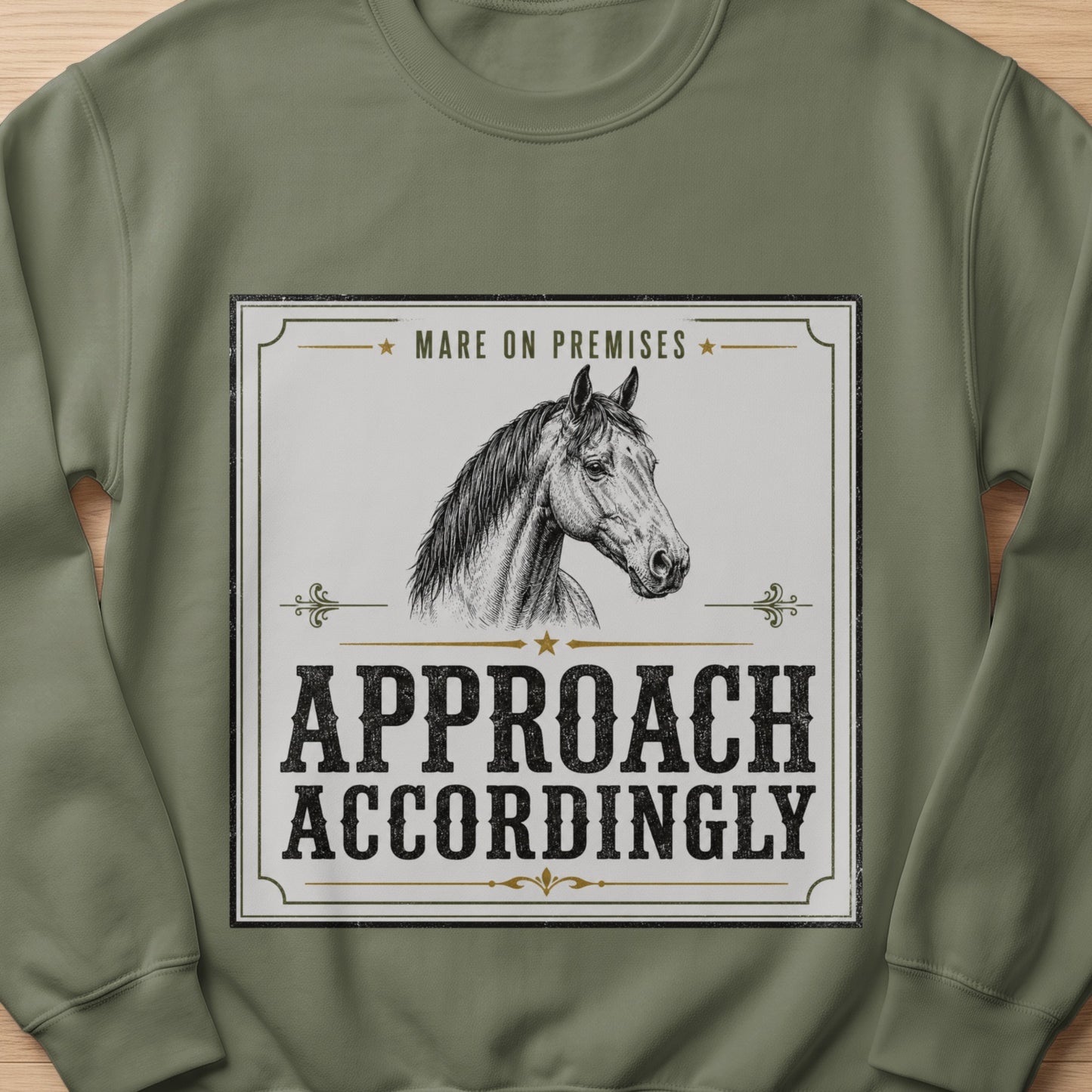 "Mare On Premises Approach Accordingly" text with horse graphic on olive green sweatshirt.