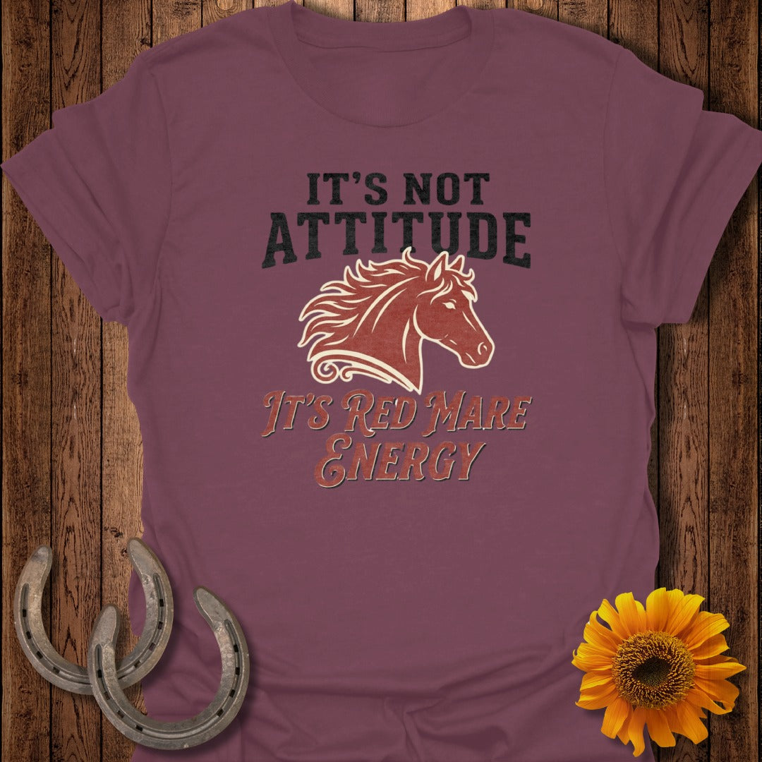 Maroon t-shirt with text "It's Not Attitude, It's Red Mare Energy" and horse graphic.