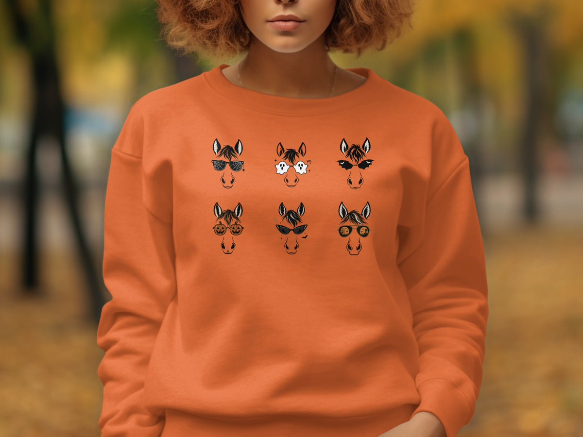 Orange sweatshirt with six cartoon horses wearing Halloween-themed sunglasses.