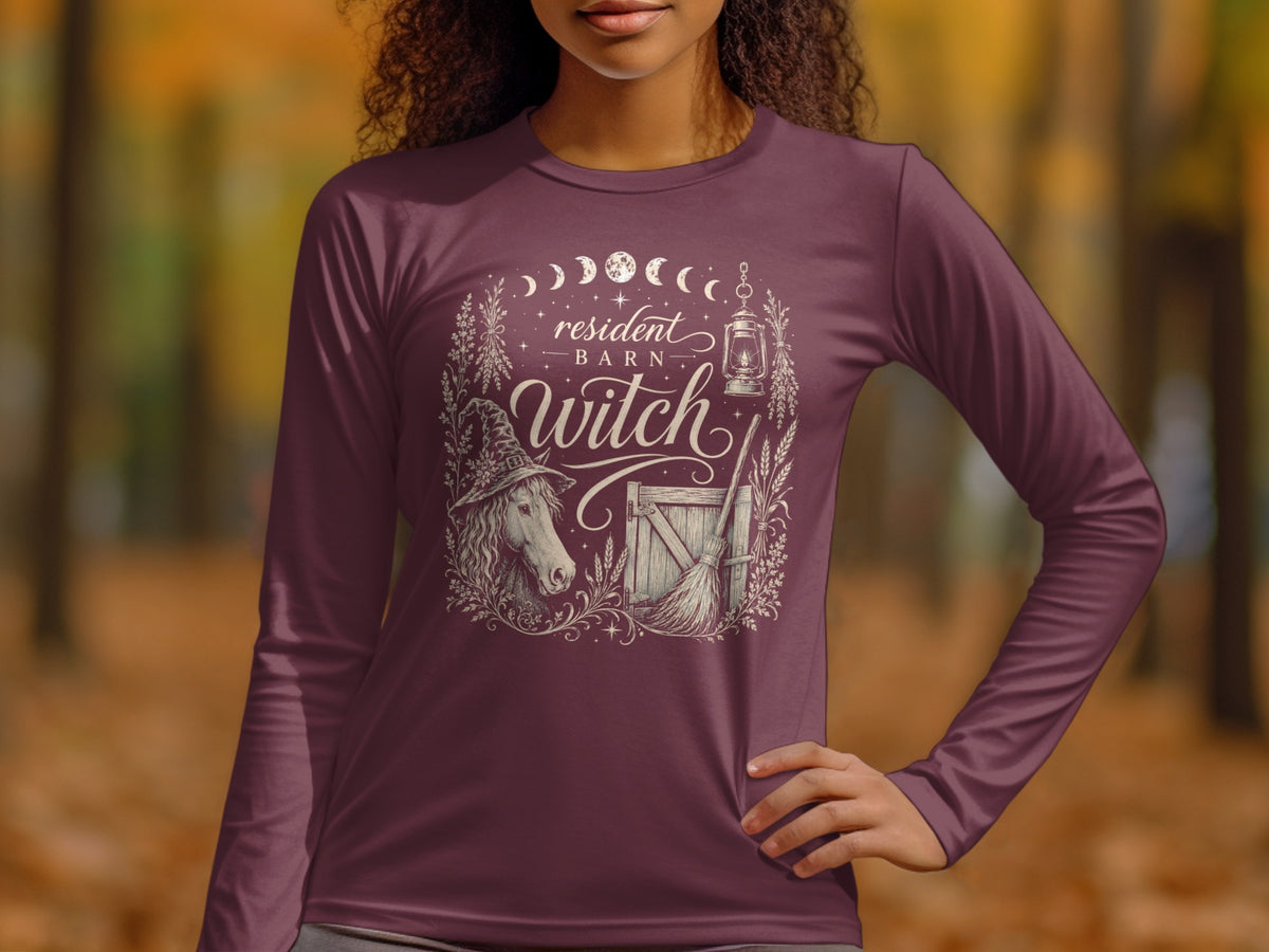 Long sleeve shirt with "resident barn witch" text and witchy barn illustration.