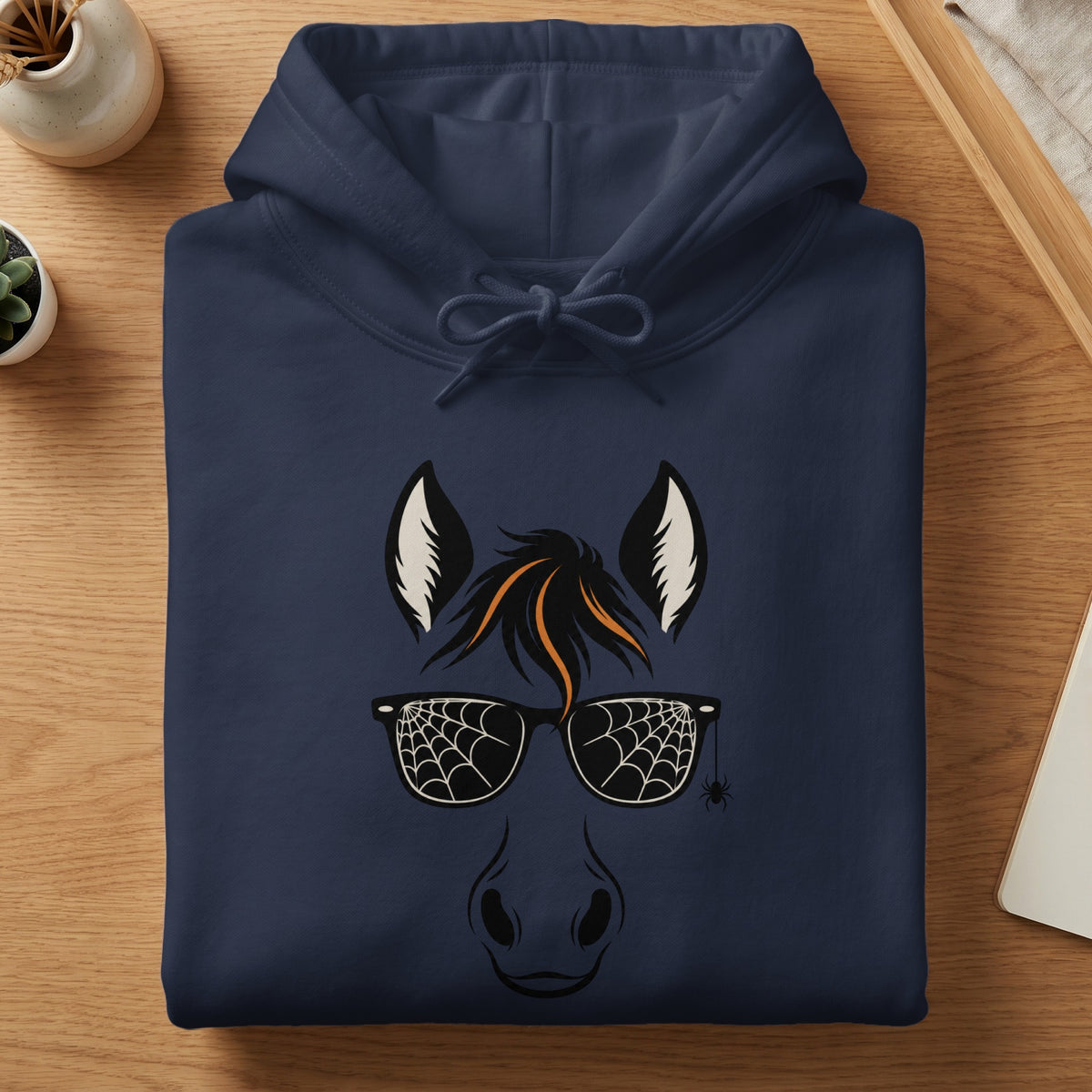 Navy hoodie with a Halloween horse face graphic wearing spiderweb sunglasses and a tiny spider.