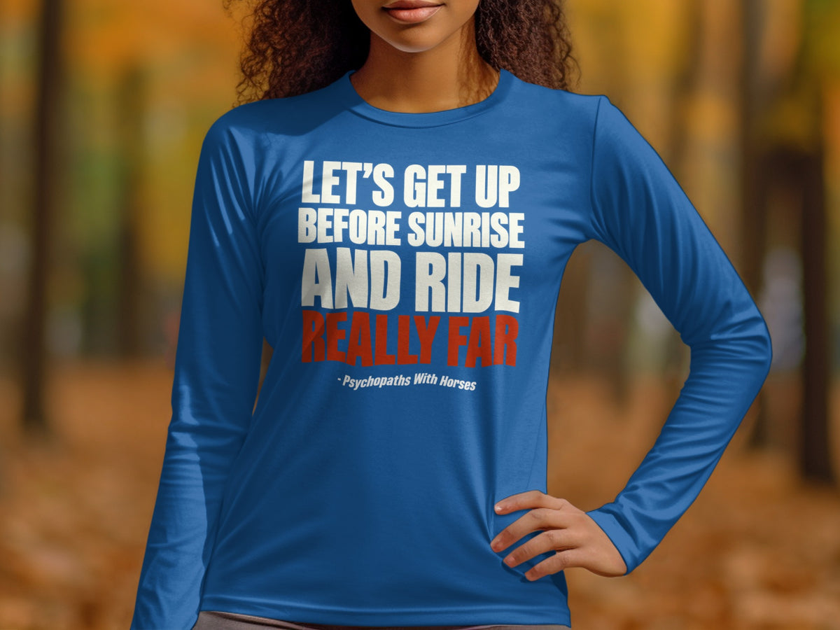 A person wearing a royal blue long-sleeve shirt with the phrase LET'S GET UP BEFORE SUNRISE AND RIDE REALLY FAR printed on the chest.