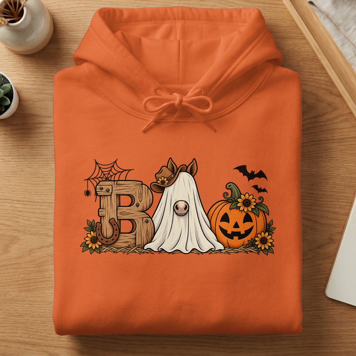 Orange hoodie with a Halloween graphic featuring a ghost horse, pumpkin, and "Boo" text.