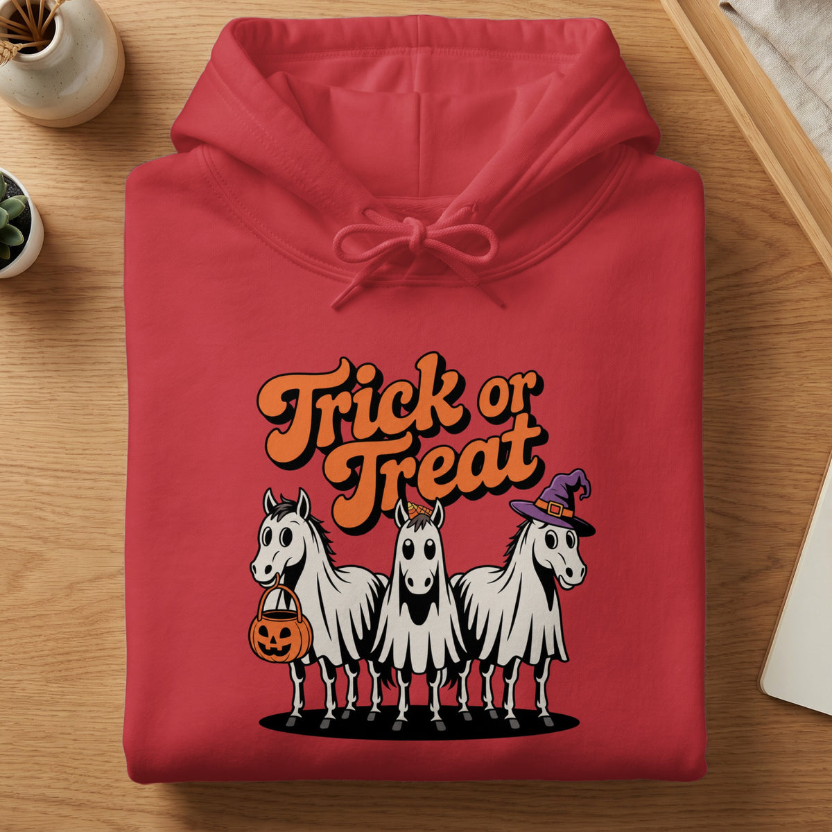 Red hoodie with "Trick or Treat" text and three ghost horses wearing Halloween costumes.