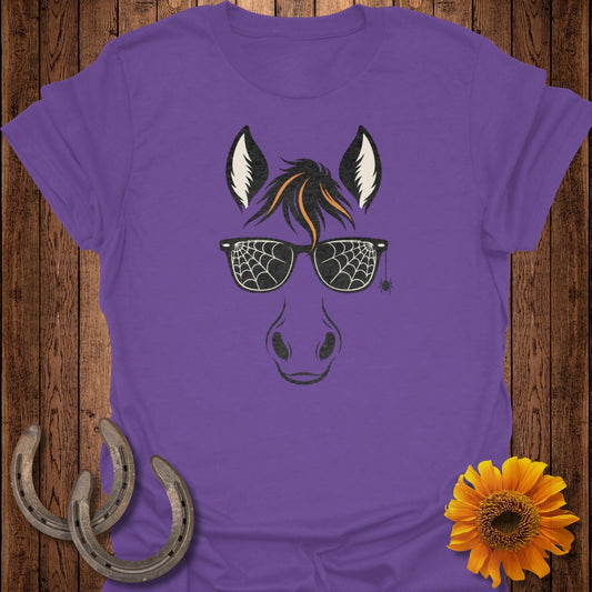 Purple t-shirt with a horse's face graphic wearing spiderweb sunglasses and a tiny spider.