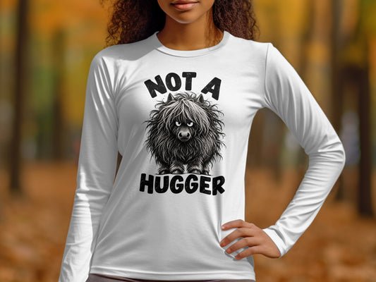 White long-sleeve shirt with black text and illustration of a shaggy creature.