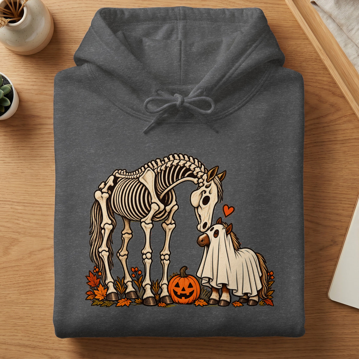Skeleton horse and ghost horse with pumpkin and autumn leaves graphic on hoodie.