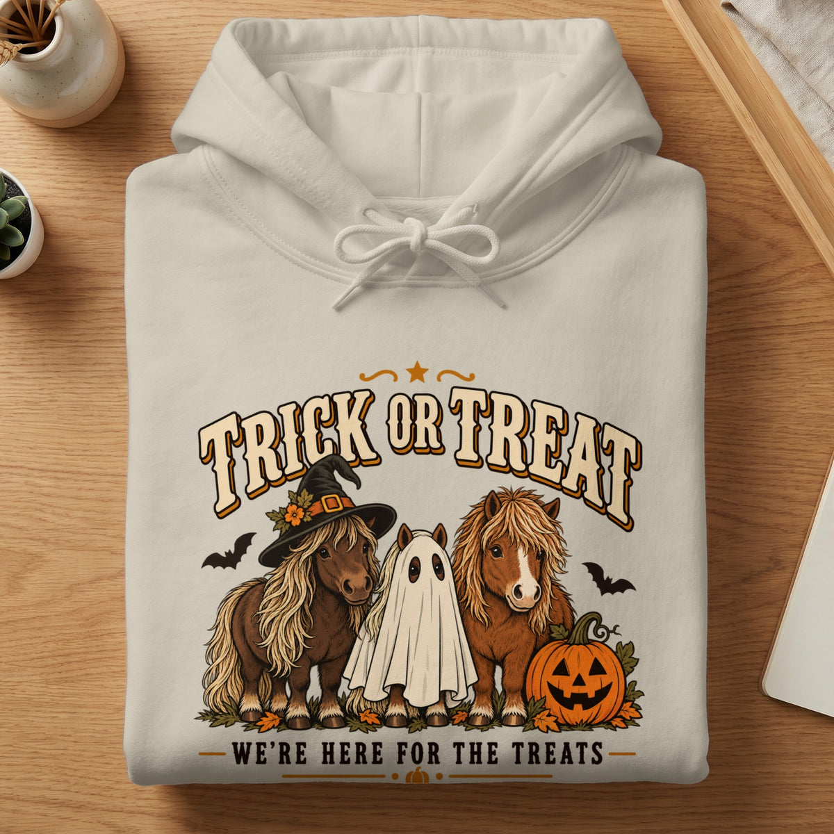 Cream hoodie with "Trick or Treat" and three horses, one in a ghost costume.