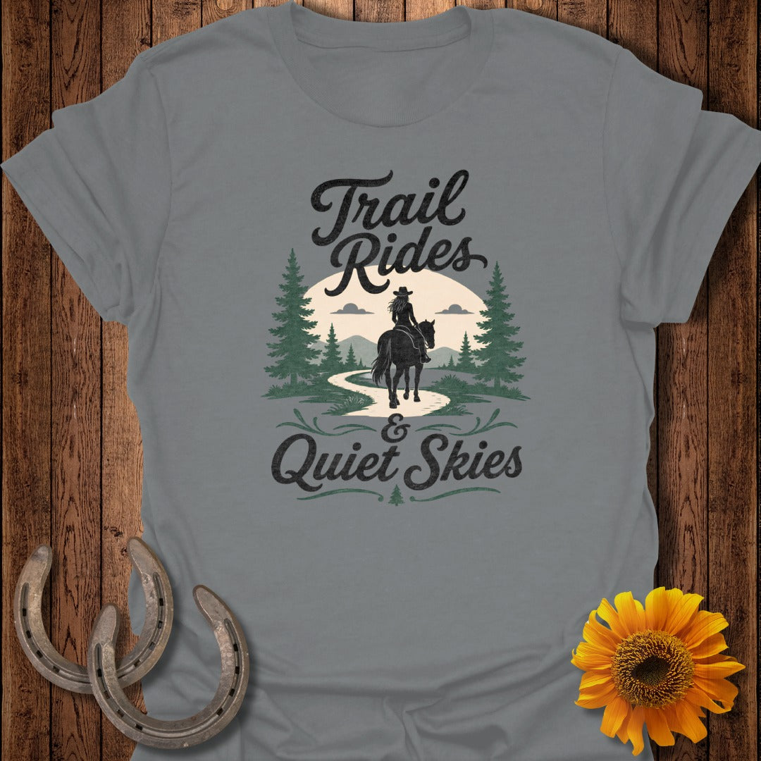 T-shirt with "Trail Rides & Quiet Skies" text and horse rider in forest scene.