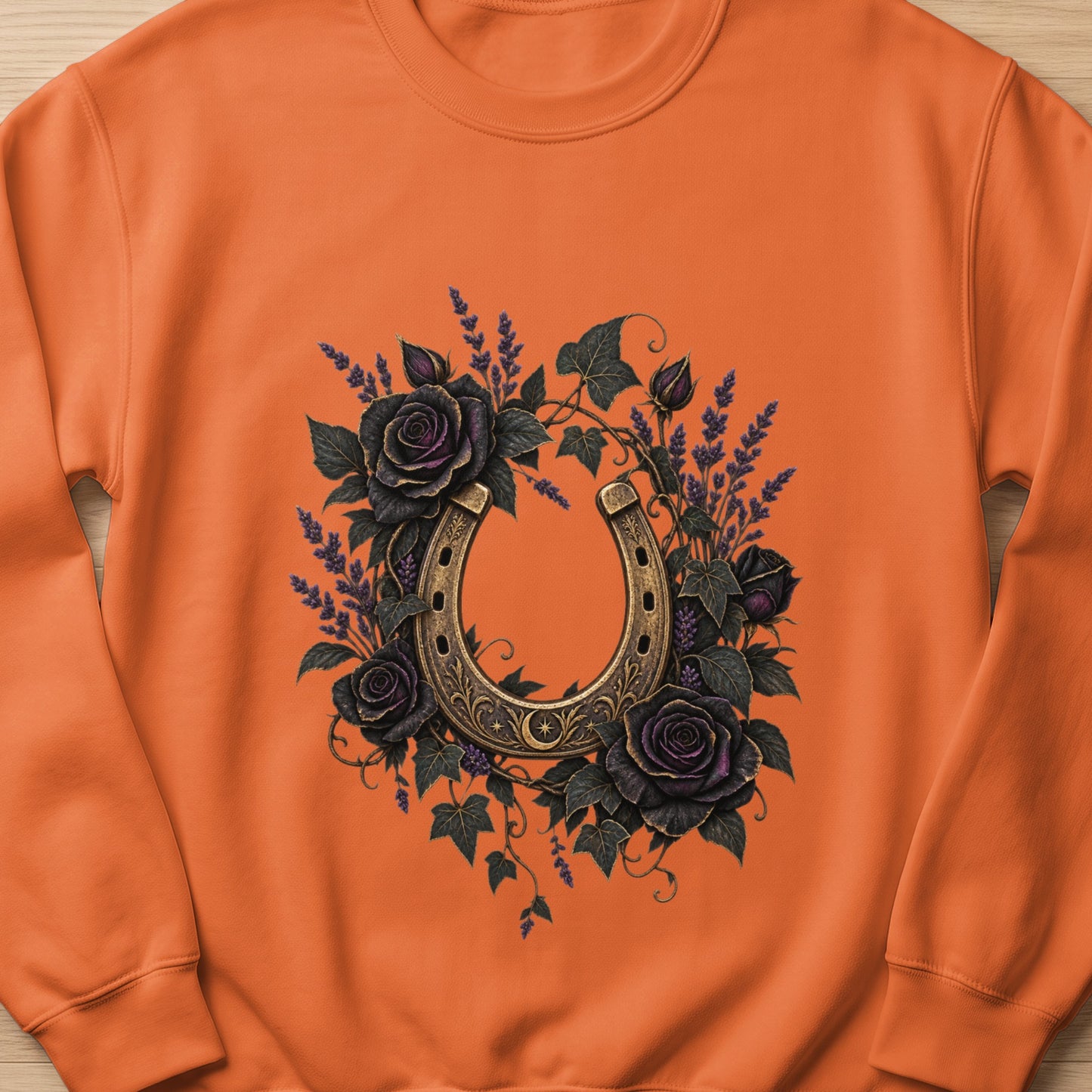 Orange sweatshirt with a gold horseshoe and dark roses design.