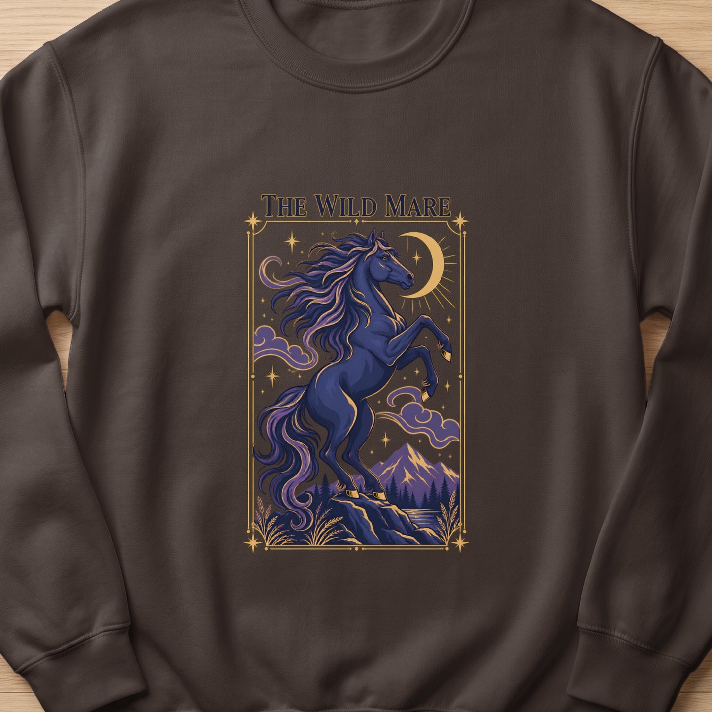 The Wild Mare text above a dark blue horse rearing by a crescent moon and stars.