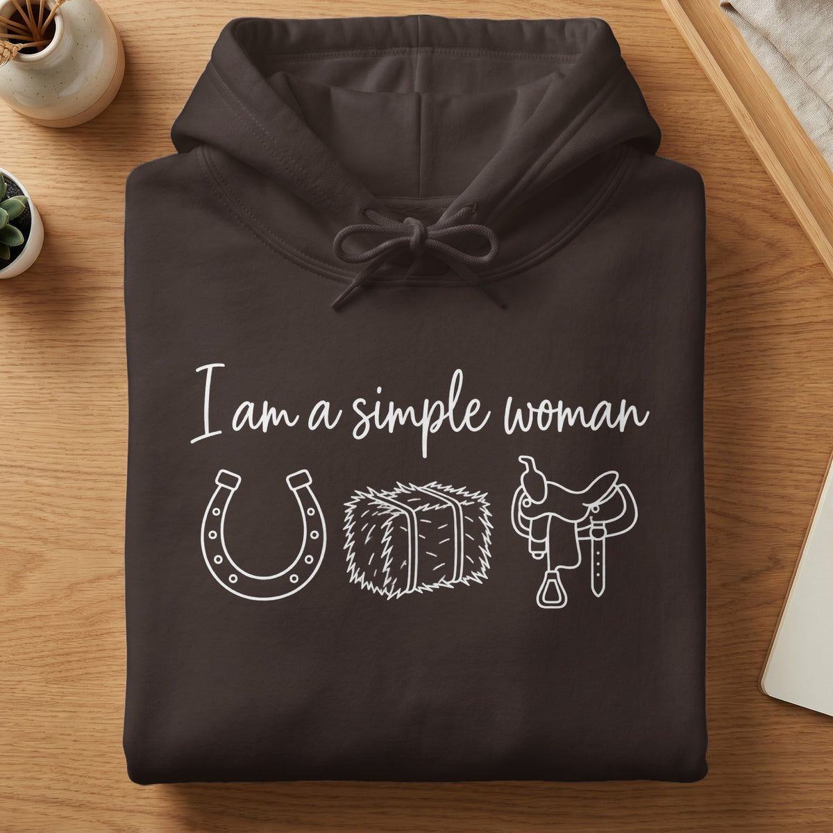 Brown hoodie with white text "I am a simple woman" and western icons.