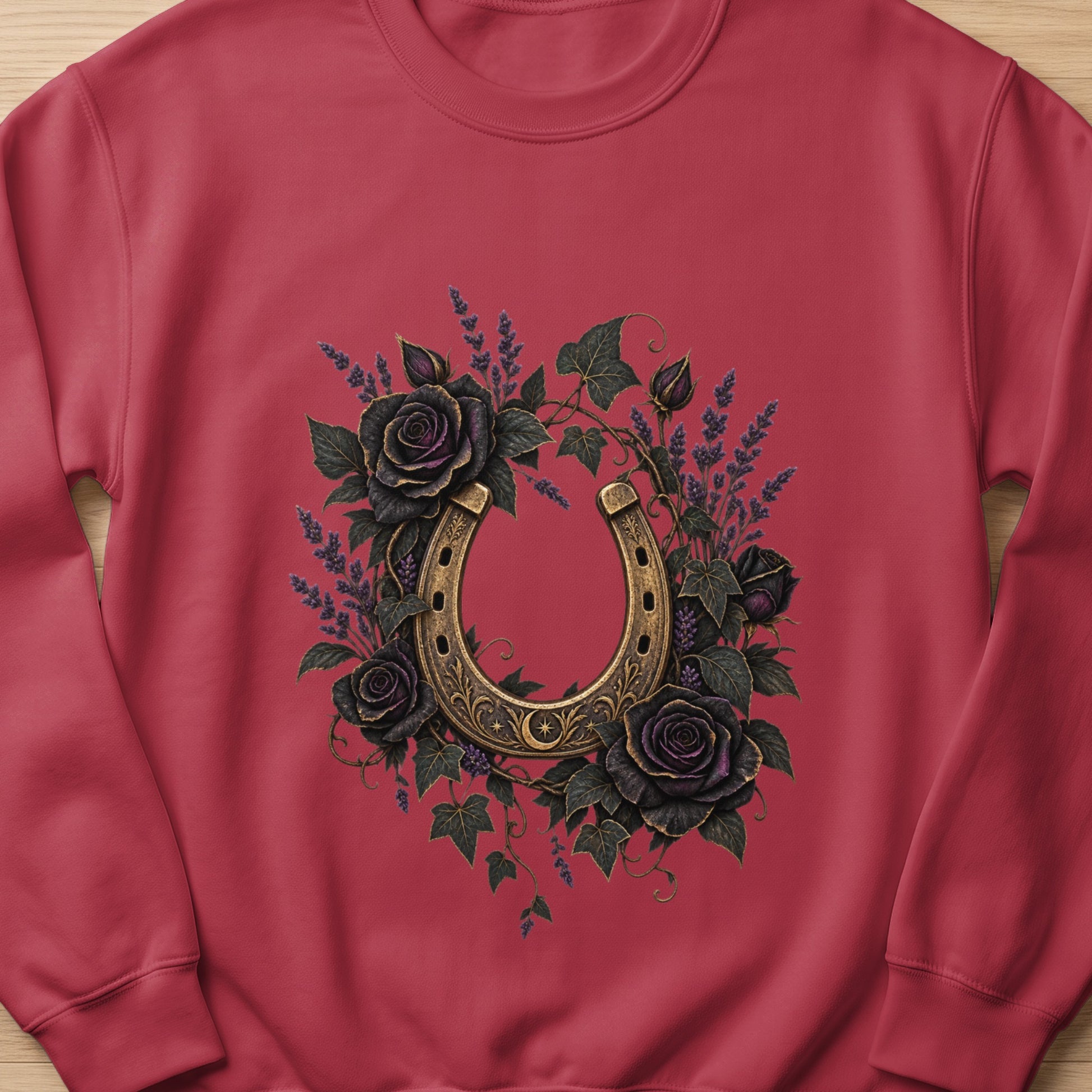Horseshoe surrounded by dark roses and lavender on a red sweatshirt.