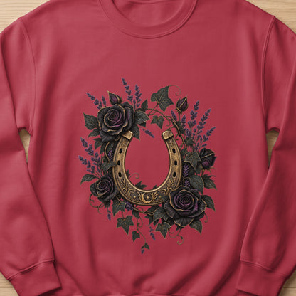Horseshoe surrounded by dark roses and lavender on a red sweatshirt.