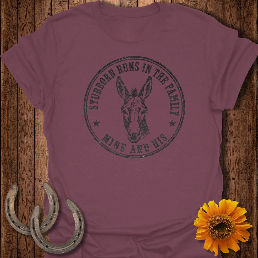 Burgundy t-shirt with donkey graphic and text "Stubborn runs in the family mine and his".