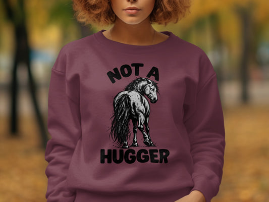 Maroon sweatshirt with black graphic of a horse and text "NOT A HUGGER".
