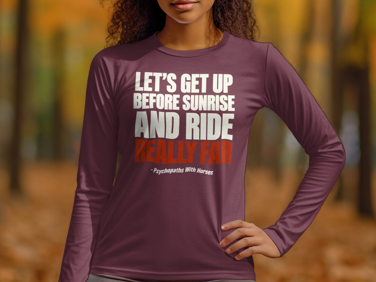 A person wearing a plum-colored long-sleeved shirt printed with white and red text.