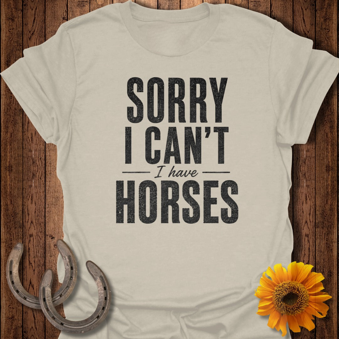 Light beige t-shirt with "SORRY I CAN'T - I have HORSES" printed in black text.