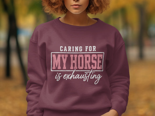 Maroon sweatshirt with text "Caring for my horse is exhausting."