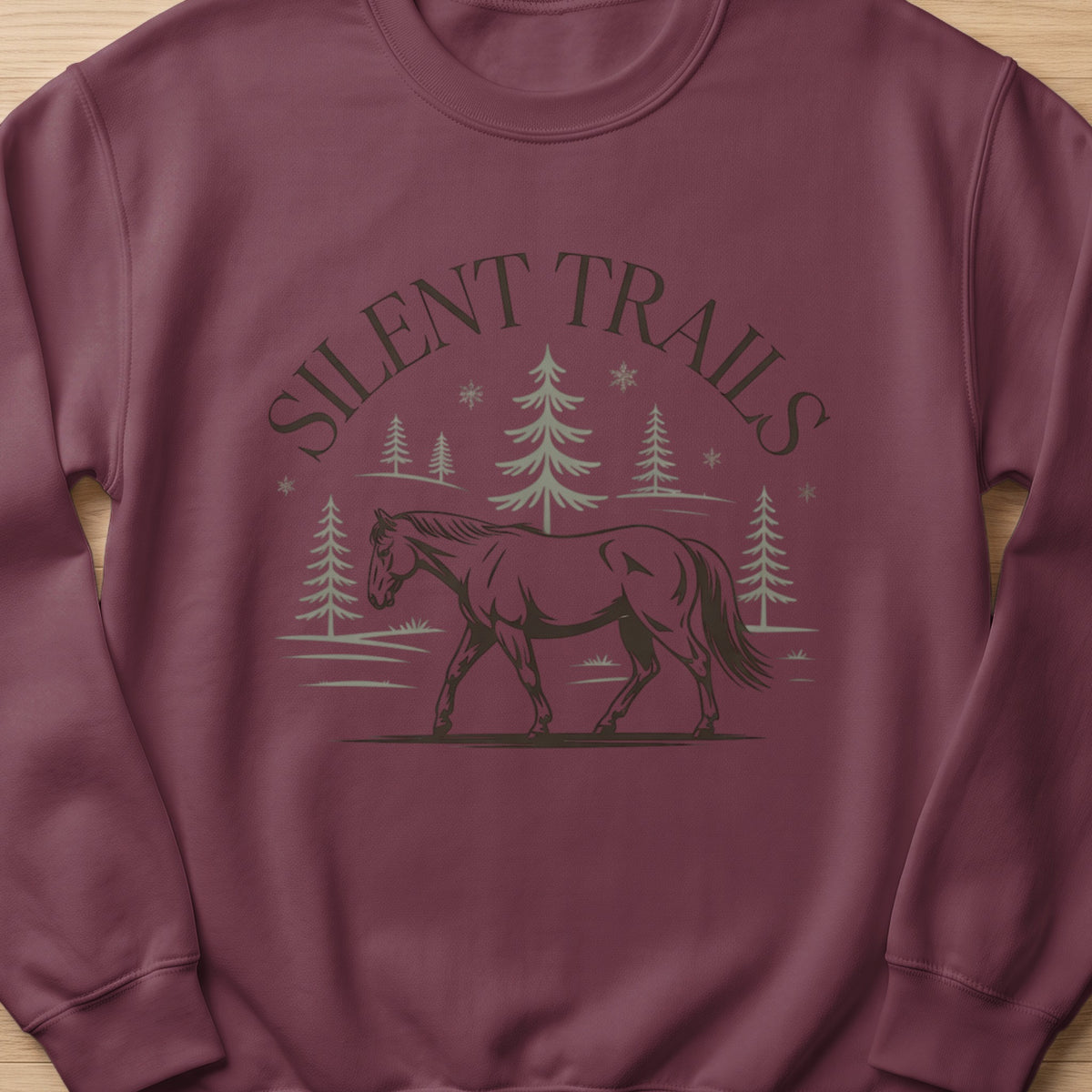 Maroon sweatshirt with "Silent Trails" text above a walking horse and trees.