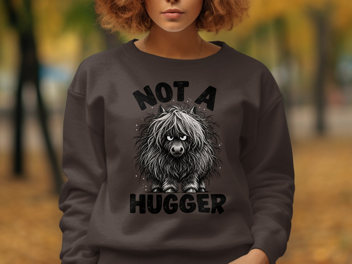 Dark gray sweatshirt with a drawing of a fluffy cow and text "NOT A HUGGER".
