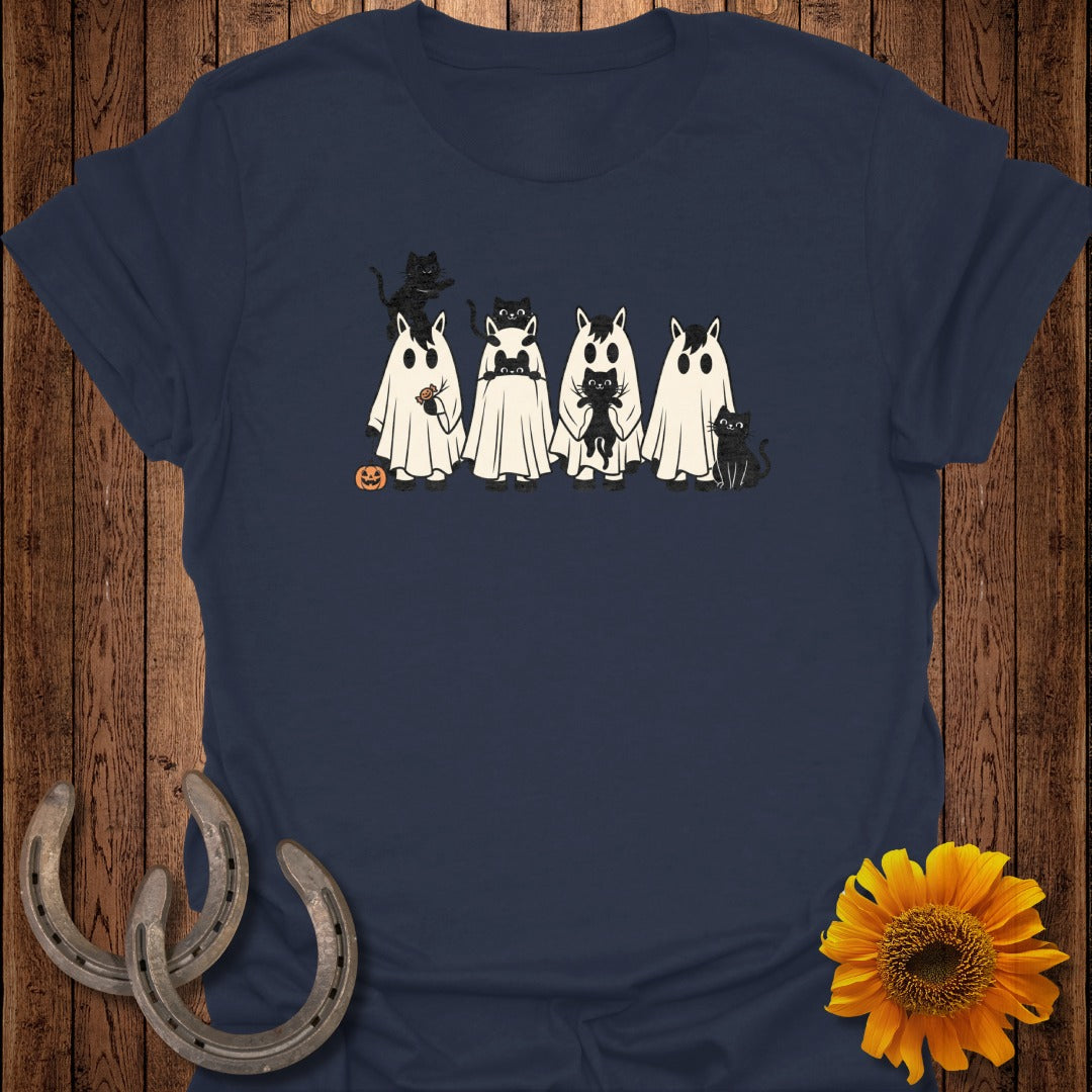 T-shirt with black cats dressed as ghosts, and a small pumpkin.