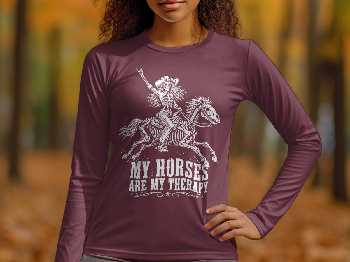 Skeleton riding a horse with text "My Horses Are My Therapy" on maroon shirt.