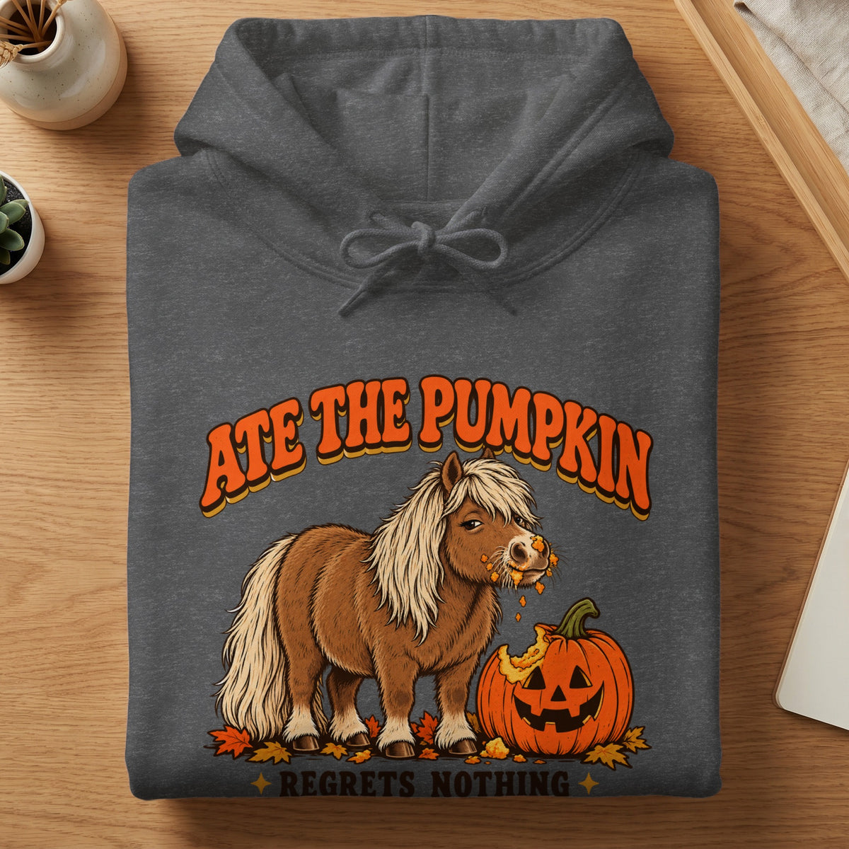 Pony eating pumpkin with text "ATE THE PUMPKIN REGRETS NOTHING"
